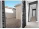 View from inside home onto patio with tiled flooring and block wall at 14562 W Georgia Ave, Litchfield Park, AZ 85340