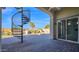 Covered patio with spiral staircase offers seamless indoor-outdoor living and a scenic backyard view at 14562 W Georgia Ave, Litchfield Park, AZ 85340