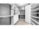 Walk-in closet with custom shelves, drawers, and ample storage space at 14562 W Georgia Ave, Litchfield Park, AZ 85340