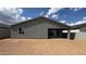 Home exterior showing backyard with patio and sliding glass doors at 15769 W Cheryl Dr, Waddell, AZ 85355