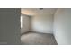 This bedroom has neutral walls, carpet flooring, and a window at 15769 W Cheryl Dr, Waddell, AZ 85355