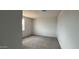 Spacious bedroom with neutral carpet and a bright window at 15769 W Cheryl Dr, Waddell, AZ 85355