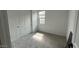 This bedroom features white walls, a window, carpet flooring, and a closet with sliding doors at 15769 W Cheryl Dr, Waddell, AZ 85355