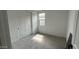 Bright bedroom features neutral carpet, a large window, and spacious closet at 15769 W Cheryl Dr, Waddell, AZ 85355