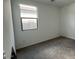 Cozy bedroom featuring carpet flooring, baseboard trim, and a bright window at 15769 W Cheryl Dr, Waddell, AZ 85355