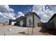Modern single-story home with a three-car garage, desert landscaping, and a paver driveway at 15769 W Cheryl Dr, Waddell, AZ 85355