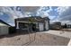 Charming single-story home with a two-car garage, desert landscaping, and a young tree in the front yard at 15769 W Cheryl Dr, Waddell, AZ 85355