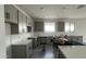 Spacious kitchen featuring gray cabinets, white subway tile backsplash, and expansive countertop space at 15769 W Cheryl Dr, Waddell, AZ 85355