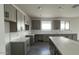 Newly renovated kitchen featuring gray cabinets, a white backsplash, and stainless steel appliances at 15769 W Cheryl Dr, Waddell, AZ 85355