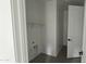 Functional laundry room featuring a shelf, hookups, neutral paint, and wood-look tile flooring at 15769 W Cheryl Dr, Waddell, AZ 85355
