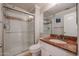 Bathroom featuring a tiled walk-in shower, granite countertop, and a framed mirror at 1701 E Colter St # 10, Phoenix, AZ 85016