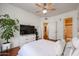 Bright bedroom features white decor, hardwood floors, and flatscreen TV at 1701 E Colter St # 10, Phoenix, AZ 85016