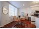 Bright dining area with modern furniture, natural light, and hardwood floors at 1701 E Colter St # 10, Phoenix, AZ 85016