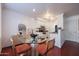 Cozy dining area with a glass table, seating four, and views into the kitchen at 1701 E Colter St # 10, Phoenix, AZ 85016
