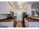 Updated kitchen featuring stainless steel appliances, white cabinetry, and granite countertops at 1701 E Colter St # 10, Phoenix, AZ 85016