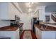 Bright kitchen with stainless steel appliances, white cabinets, and a stylish area rug at 1701 E Colter St # 10, Phoenix, AZ 85016