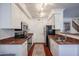 Beautiful kitchen featuring stainless steel appliances, white cabinetry, and granite countertops at 1701 E Colter St # 10, Phoenix, AZ 85016