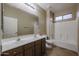 Bathroom with double sinks, dark wood cabinets, tile flooring and tub and shower combo at 18457 W Ivy Ln, Surprise, AZ 85388