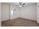 Bedroom with carpet flooring, and a arched window bringing in lots of natural light at 18457 W Ivy Ln, Surprise, AZ 85388