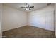 Bedroom featuring neutral walls, carpet flooring, ceiling fan and a closet with sliding doors at 18457 W Ivy Ln, Surprise, AZ 85388