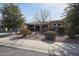 Beautiful single-story home with desert landscaping, mature trees, and a charming facade at 18457 W Ivy Ln, Surprise, AZ 85388