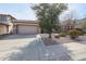 Charming home with a two-car garage and drought-resistant landscaping at 18457 W Ivy Ln, Surprise, AZ 85388