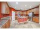 Well-lit kitchen offers an island, stainless steel appliances, cabinets, and expansive counter space at 18457 W Ivy Ln, Surprise, AZ 85388