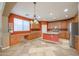 Spacious kitchen features an island, stainless steel appliances, stylish light fixture, and a window at 18457 W Ivy Ln, Surprise, AZ 85388