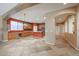 Open-concept kitchen boasts an island, stainless steel appliances, tile floors, and ample counter space at 18457 W Ivy Ln, Surprise, AZ 85388
