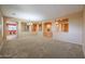 Expansive living room featuring a large open space and architectural details connecting to other rooms at 18457 W Ivy Ln, Surprise, AZ 85388