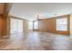 Spacious living room featuring tile flooring, a ceiling fan, and natural light at 18457 W Ivy Ln, Surprise, AZ 85388