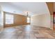 Large room with tile floors, ceiling fan, and bright windows providing ample natural light and ventilation at 18457 W Ivy Ln, Surprise, AZ 85388