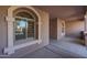 The home's covered porch leads to the front door and living space at 18457 W Ivy Ln, Surprise, AZ 85388