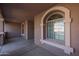 Arched windows punctuate the front of the home's covered porch at 18457 W Ivy Ln, Surprise, AZ 85388