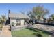 The backyard features a cozy sitting area with manicured lawn and beautiful brick accents at 1926 W Holly St, Phoenix, AZ 85009