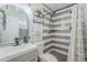 Contemporary bathroom with a modern vanity, stylish mirror, and tiled walk-in shower at 1926 W Holly St, Phoenix, AZ 85009
