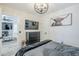 Bedroom features modern light fixture, flat screen tv, modern dresser and view into adjacent living space at 1926 W Holly St, Phoenix, AZ 85009