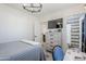 Bedroom features wood-look floors, modern light fixture, desk space, view into bathroom and bed at 1926 W Holly St, Phoenix, AZ 85009