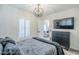 Bedroom features modern light fixture, flat screen tv, modern dresser and view into living space at 1926 W Holly St, Phoenix, AZ 85009