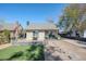 Charming home with a landscaped yard, stone walkway, and neutral stucco exterior at 1926 W Holly St, Phoenix, AZ 85009