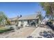 Charming exterior featuring a cozy front porch with a seating area and a well-maintained front yard landscape at 1926 W Holly St, Phoenix, AZ 85009