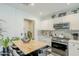 Modern kitchen featuring an island with barstool seating and white cabinets at 1926 W Holly St, Phoenix, AZ 85009