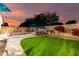 Serene backyard with a refreshing pool, comfortable seating area, and lush artificial grass at 20729 E Canary Way, Queen Creek, AZ 85142