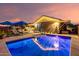 Beautiful backyard featuring a sparkling pool, patio seating, and well-maintained landscaping at 20729 E Canary Way, Queen Creek, AZ 85142