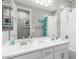 Bright bathroom featuring double sinks, a large mirror, and a separate bathtub and shower with unique decor at 20729 E Canary Way, Queen Creek, AZ 85142