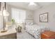 Cozy bedroom with natural light, complemented by a floral-patterned bedspread and classic decor at 20729 E Canary Way, Queen Creek, AZ 85142