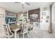 Inviting dining room with stylish decor, featuring built-in shelves, a wooden accent wall, and a contemporary ceiling fan at 20729 E Canary Way, Queen Creek, AZ 85142