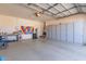 Spacious garage featuring an epoxy floor, storage cabinets, and ample room for parking and projects at 20729 E Canary Way, Queen Creek, AZ 85142