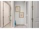 Inviting hallway with tile flooring, tastefully adorned with artwork, leading to various rooms at 20729 E Canary Way, Queen Creek, AZ 85142