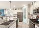 Bright and airy kitchen featuring white cabinets, granite countertops, stainless steel appliances, and a convenient island with seating at 20729 E Canary Way, Queen Creek, AZ 85142